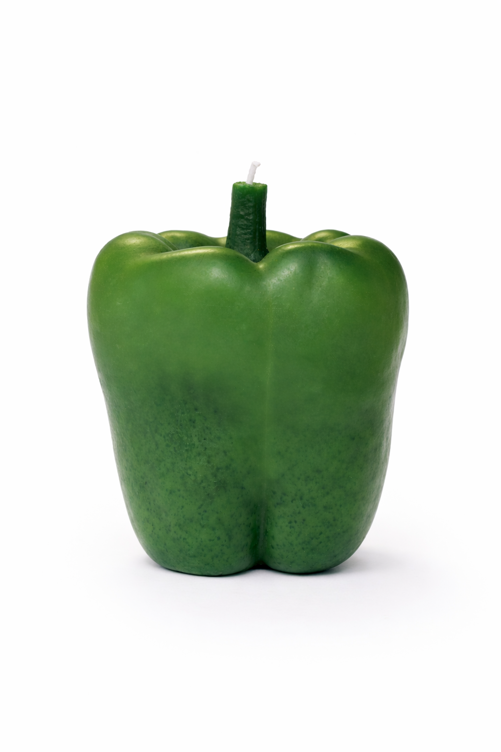 Green bell pepper-shaped candle on a white background