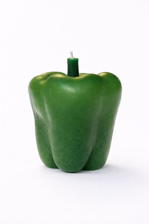 Green bell pepper-shaped candle on a white background