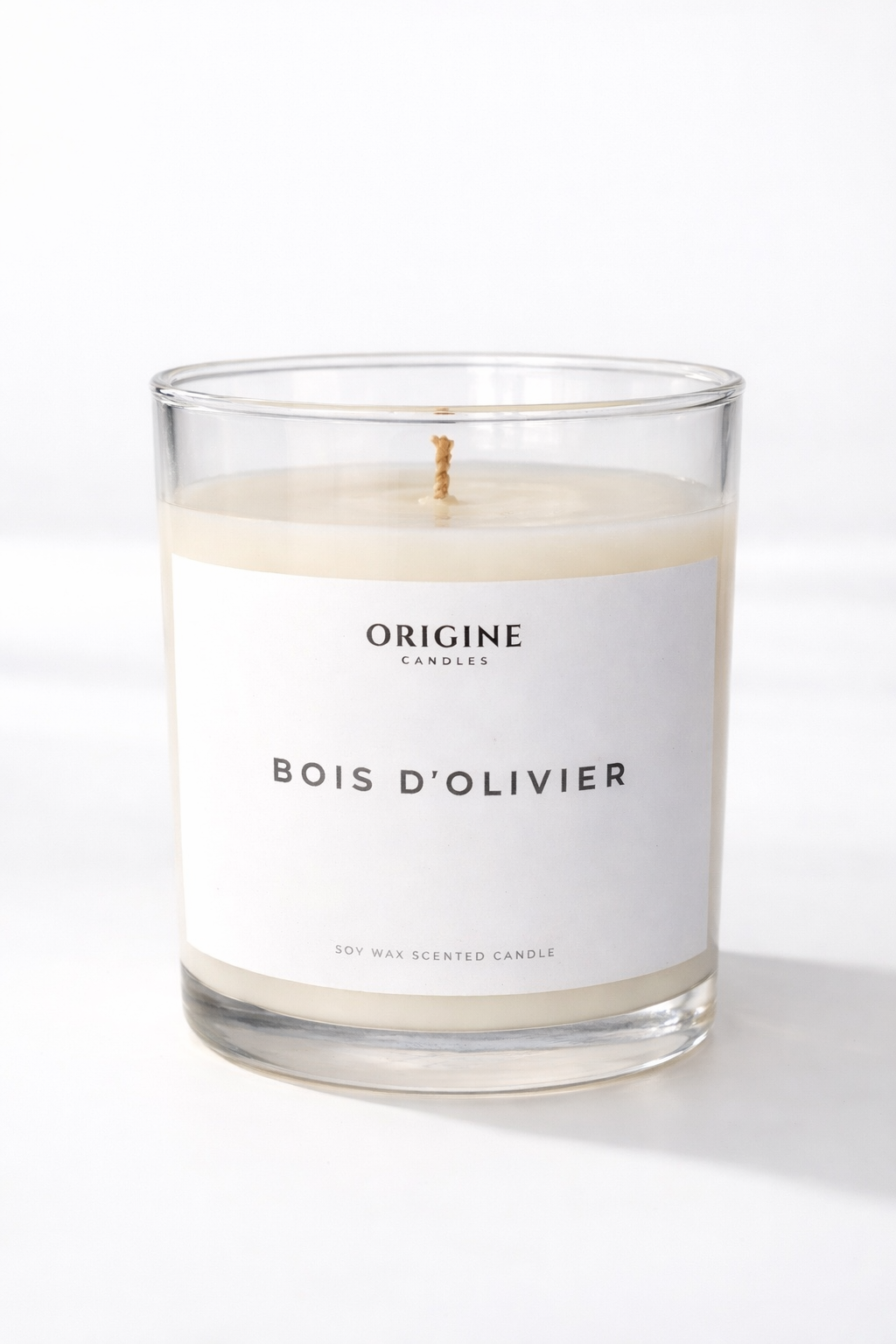 scented candle with cypress, cedar, olive leaves, and soft amber woods evoking natural calm and refinement