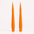 Two tall, CARROT candles on a white background