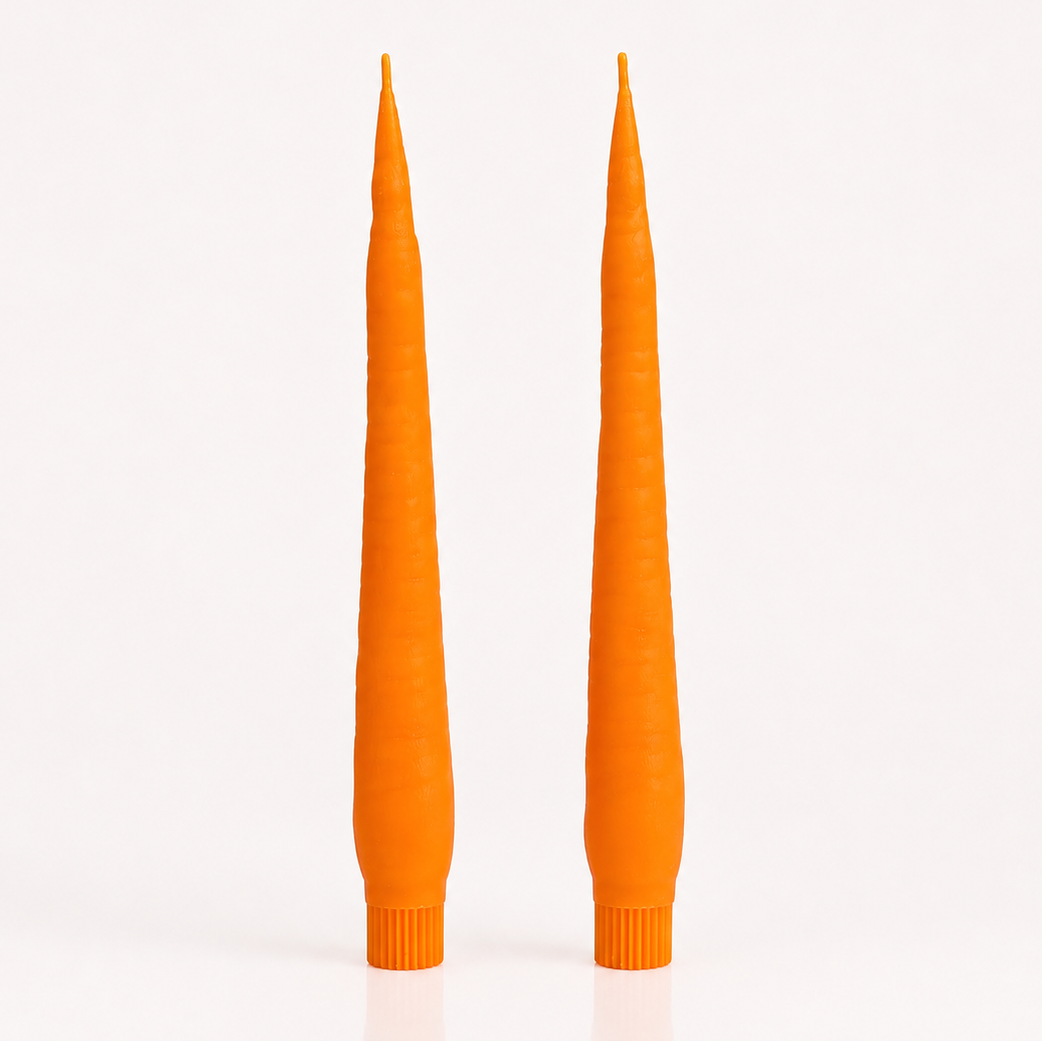Two tall, CARROT candles on a white background